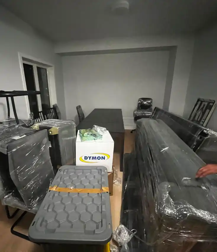 Professional movers packing furniture and loading a truck for a long distance move